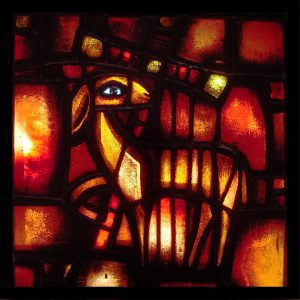 Taizé Lamb of God window. Adapted from https://www.flickr.com/photos/swperman/221072670/ under CC BY-NC-SA 2.0.